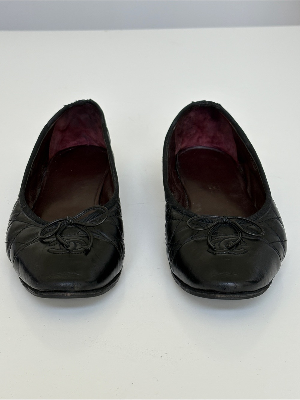 CHANEL Black Quilted Leather Ballet Flats with CC and Bow Accent